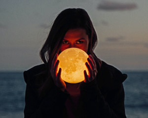 woman holding moon orb
